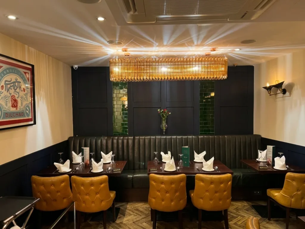 Interior of Dilchad family run Indian restaurant London, warm dining room near Liverpool Street